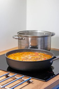 pan and pot on electric induction stove in kitchen