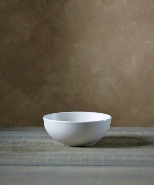 empty white bowl on kitchen table, wall background