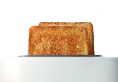 toasted bread slices in toaster on white background