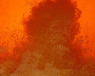 Close up background texture of pouring beer with bubbles