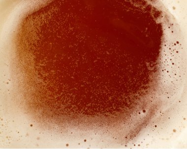 Close up background texture of beer with and froth, top view
