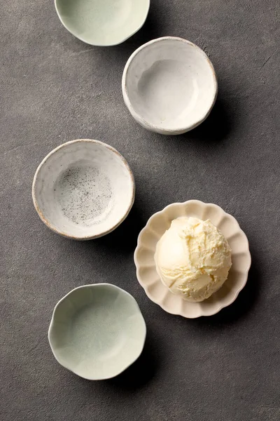 各种空的和一个完整的冰淇淋碗在深灰色厨房桌子上 顶部视图 — 图库照片