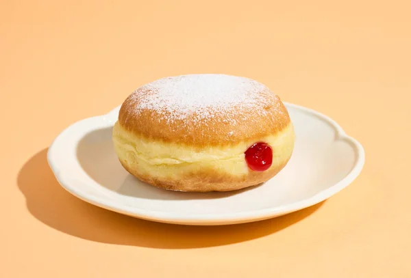 Freshly Baked Jelly Donut White Plate Isolated Orange Background — Stock Photo, Image