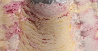 yaban mersini, mascarpone ve vanilyalı dondurma metal kaşıkla konteynırdan çıkartılıyor.