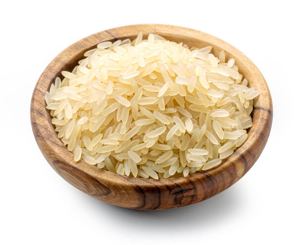 bowl of raw uncooked rice isolated on white background