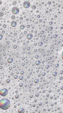 Köpüklü arka plan. Sıvı sabun köpükleri, köpük köpükleri. Köpüklü sabun köpüğü dönüyor, beyaz fon. Sabun sud makro yapısı yakın plan. Temizlik, temizlik, çamaşır, çamaşır.