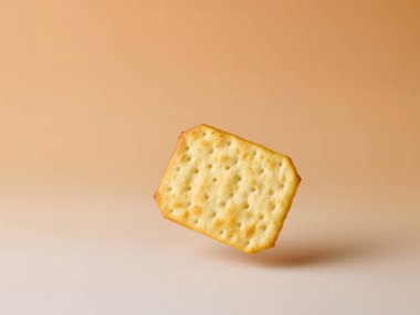 Kraker bej renk gradyan arkaplanında havalanır