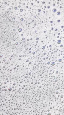 Köpüklü arka plan. Sıvı sabun köpükleri, köpük köpükleri. Köpüklü sabun köpüğü dönüyor, beyaz fon. Sabun sud makro yapısı yakın plan. Temizlik, temizlik, çamaşır, çamaşır.