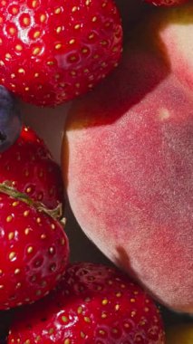 Taze, parlak yaz meyveleri ve böğürtlenlere yakın çekim, üst manzara. sağlıklı güneşli yemek geçmişi 