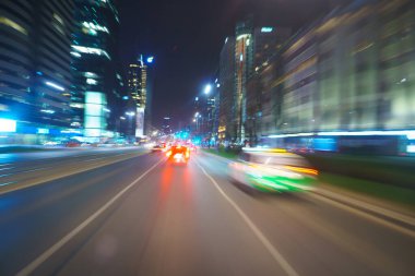 Driving through the city at night, motion blur