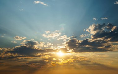 Sun at sunset and dramatic clouds