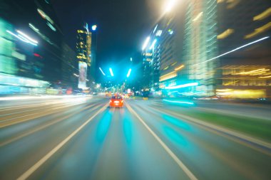 Driving through the city at night, motion blur
