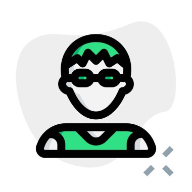 Mantar tıraşlı genç adam gözlük takıyor.