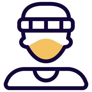 Yüz maskesi ve şapka takan genç bir delikanlı.