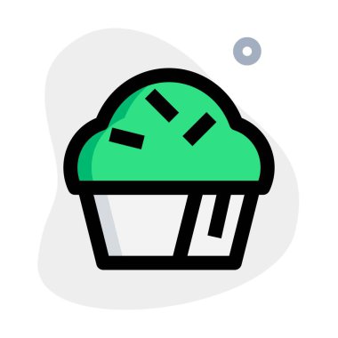 Sweet cupcake topped with flavored cream