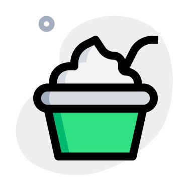 Delicious creamy yogurt bowl served with spoon.