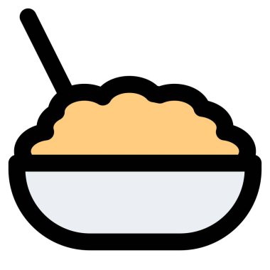 Cooked brown rice in bowl with spoon.