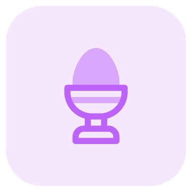 Boiled egg contained in holder.