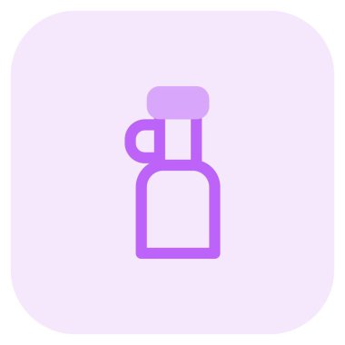 Handheld bottle of extra virgin olive oil.