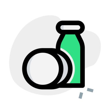 Bottle of coconut oil with coconut shell.