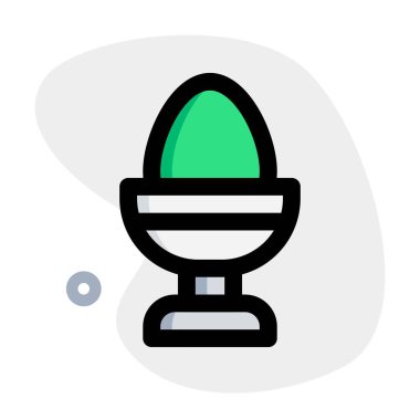 Boiled egg contained in holder.