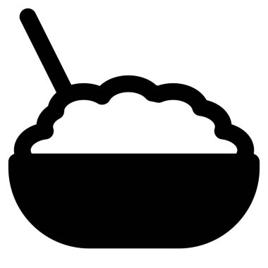 Cooked brown rice in bowl with spoon.