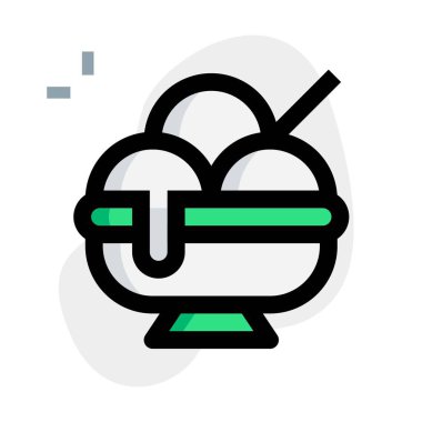 Mixed flavored melted ice cream scoops in a bowl.