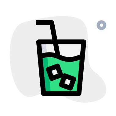 Glass of cold milk with straw and cubes.