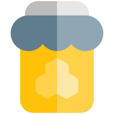 Glass jar full of sweet honey.