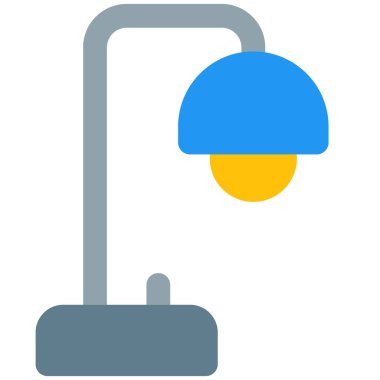 Bir iş yerinde kullanılan masa lambası.