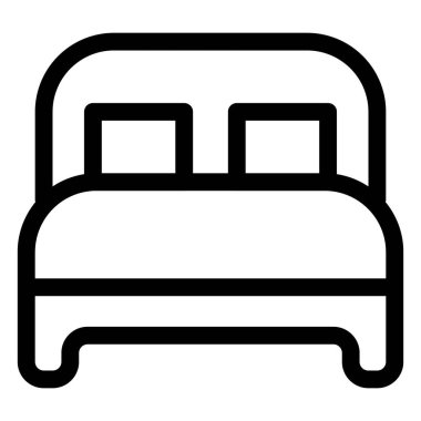 Yastıklı ve yatak başlıklı tahtadan bir yatak..