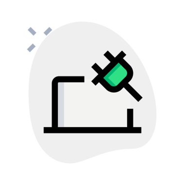 Şarj kablosuyla dizüstü bilgisayar çalıştırılıyor.