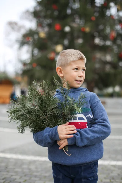 Χαριτωμένο Μικρό Αγόρι Χριστουγεννιάτικο Πουλόβερ Κρατώντας Κλαδί Ελάτης Ένα Χέρι — Φωτογραφία Αρχείου