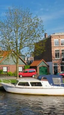 Kanaldaki tekne ve evler. Harlem, Hollanda