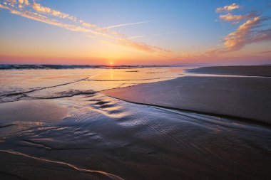 Fonte da Telha sahilinde dalgalanan dalgalarla Atlantik Okyanusu 'nun batışı, Costa da Caparica, Portekiz