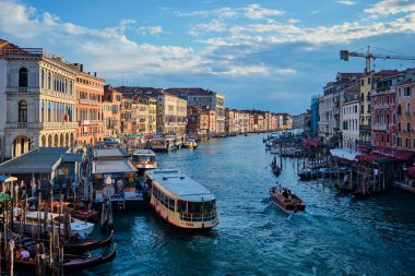 Venedik, İtalya - 27 Haziran 2018 Rialto Köprüsü, İtalya 'dan gün batımında tekneler, vaporetto ve gondollu Grand Canal