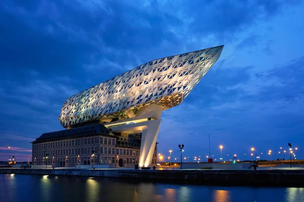 stock image ANTWERP, BELGIUM - MAY 27, 2018: Port authority house (Porthuis) designed by famous Zaha Hadid Architects which was her last project illuminated in the night