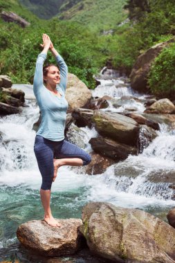 Kadın Hatha yoga denge yoga asana Vrikshasana ağacında poz şelale açık havada