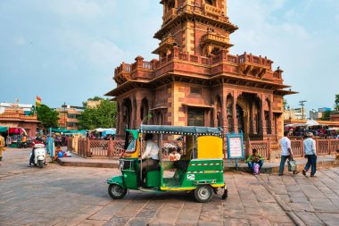 Jodhpur, India - November 14, 2019: Traffic at indian street in Sadar market near Clock Tower Ghanta Ghar. Jodhpur, Rajasthan, India clipart