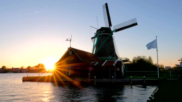 Windmill silhouette on sunset at famous tourist site Zaanse Schans in Holland. Zaandam, Netherlands