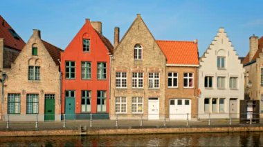 Belçika 'nın ünlü turist kasabası Bruges' de (Brugge) gün batımında eski evler ve kanallar. Kamera tavasıyla