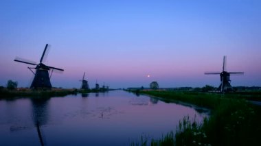 Gün batımından sonra Hollanda 'daki ünlü Kinderdijk turistik bölgesinde dramatik bir gökyüzü bulunan yel değirmenleri. Kinderdijk, Hollanda