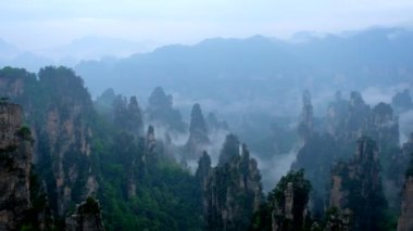 Çin - Zhangjiajie taş ünlü turistik uçurum Dağları sis bulutları Wulingyuan, Hunan, Çin, sütun. Kamera pan ile