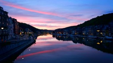 View of picturesque Dinant city over the Meuse river Dinant is a Walloon city and municipality located on the River Meuse, in the Belgian province of Namur on sunset