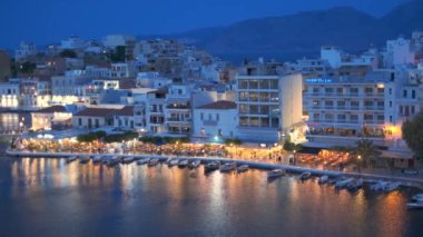AGIOS NOKOLAOS, GREECE - 19 Mayıs 2019: Voulismeni Gölü üzerindeki güzel Agios Nikolaos kasabası. Girit adasının Lasithi bölgesi, Yunanistan. Yatay kameralı.
