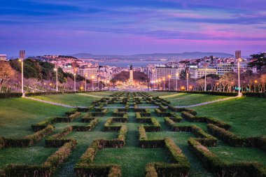 View of Lisbon Marquis of Pombal Square seen from the Eduardo VII Park in the evening twilight. Lisbon, Portugal clipart