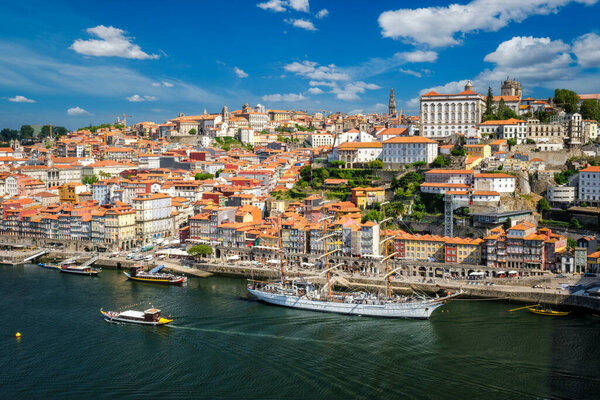 Aerial view of Porto city and Douro river with moored sailling ship from Dom Luis I bridge. Porto, Portugal