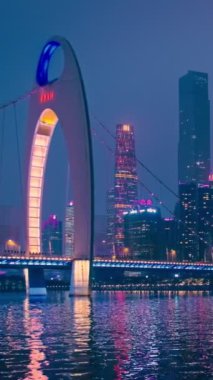 Guangzhou 'nun Zhujiang İnci Nehri üzerindeki Liede Köprüsü manzarası ve geceleri aydınlanan finansal bölgenin modern gökdelenleri. Guangzhou, Çin