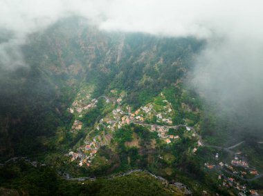 Aerial drone view of Curral das Freiras village in Valley of the Nuns from Miradouro da Eira do Serrado, Madeira island, Portugal clipart