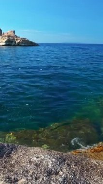 Sarakiniko sahilinin beyaz kaya oluşumları ve Ege Denizi 'nin turkuaz sularındaki yat. Milos Adası, Yunanistan. Yatay kamera tavası.